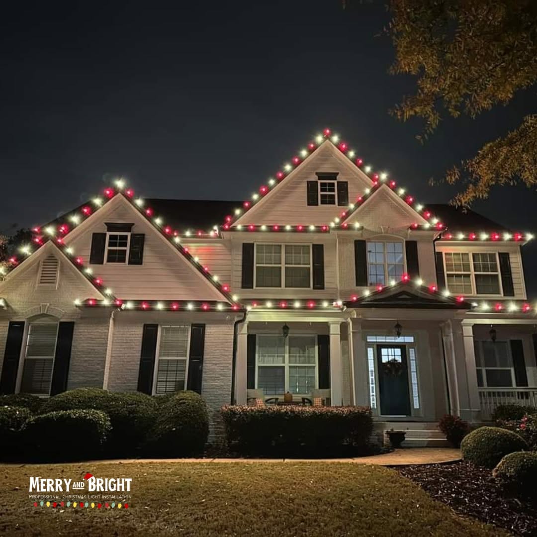 Red and warm white candy-cane roofline lighting on a Charlotte home