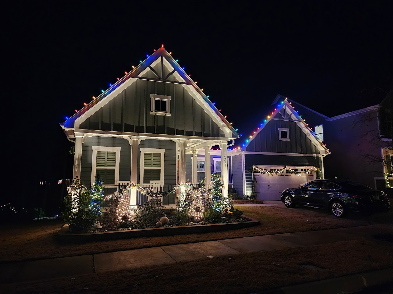 Multicolor roofline and landscape lighting on a Davidson home