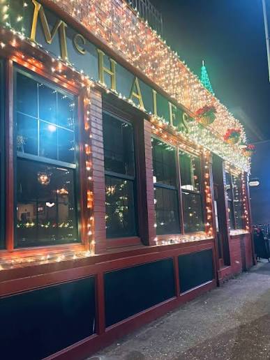 Warm white and red lighting around McHale's restaurant windows and entrance