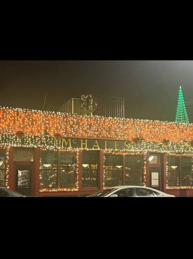 Warm white and red holiday lighting across McHale's restaurant facade
