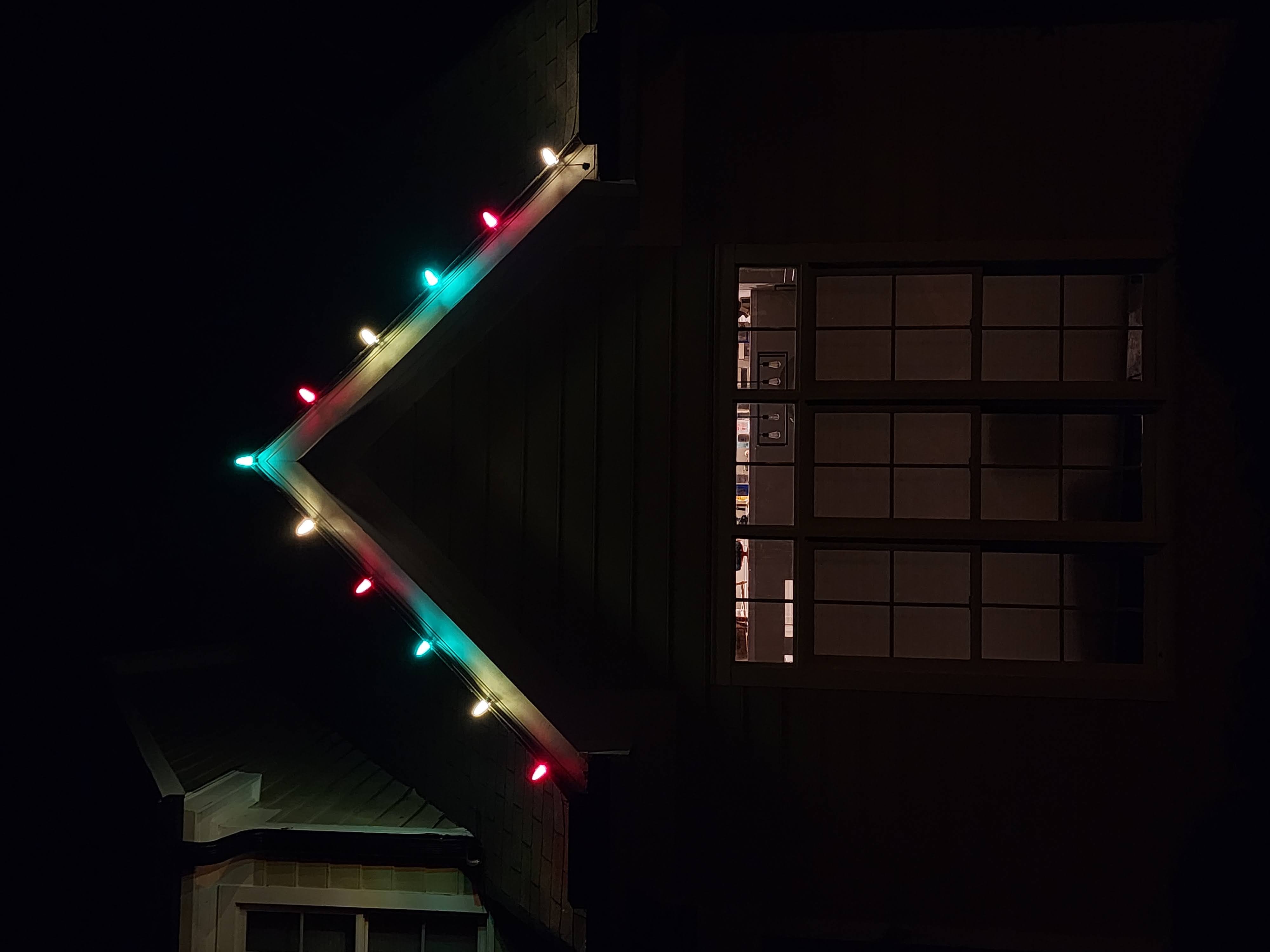 Red, green, and warm white C9 bulbs on the same sample roof peak