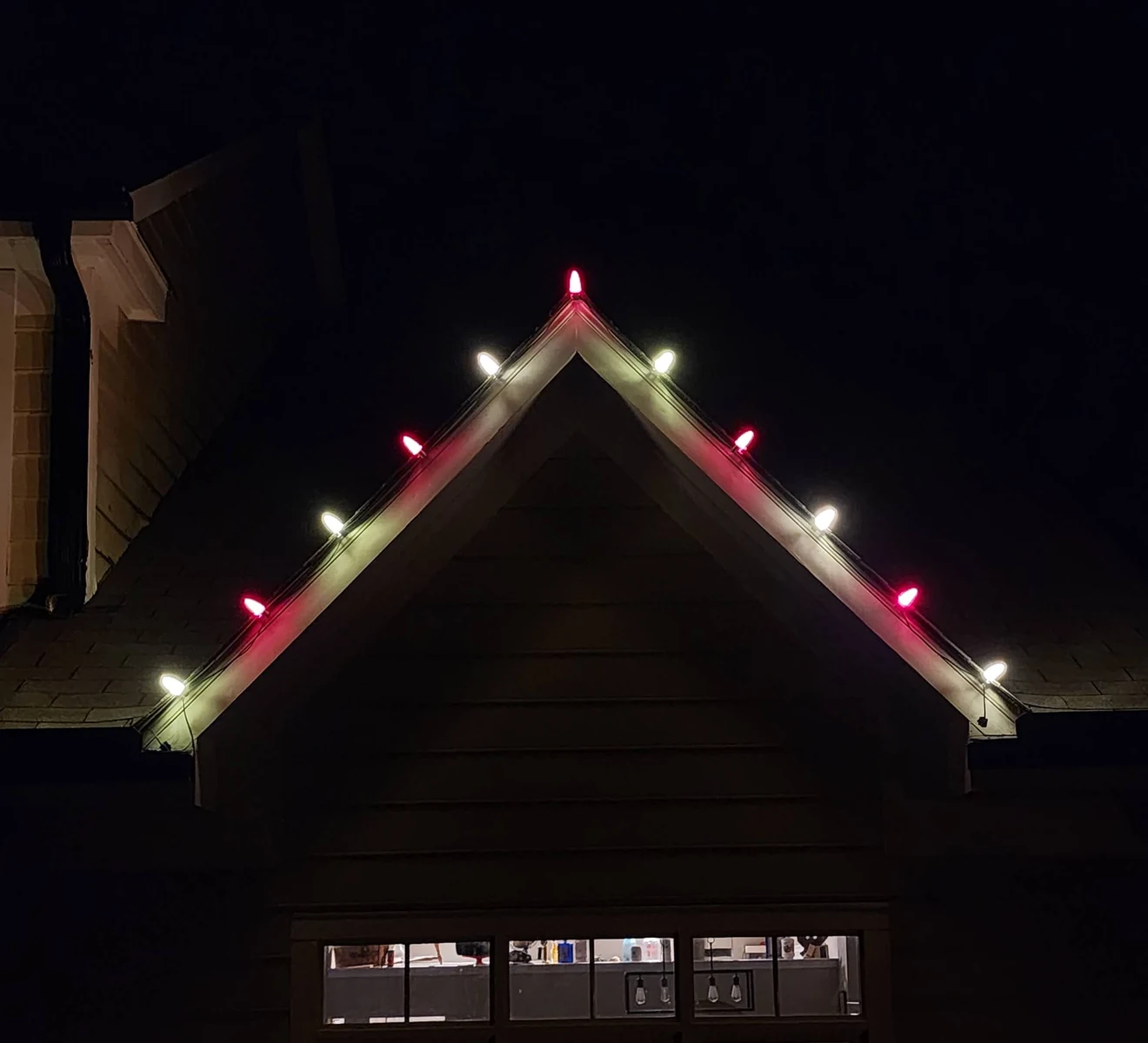 Red and warm-white bulbs along the same gable