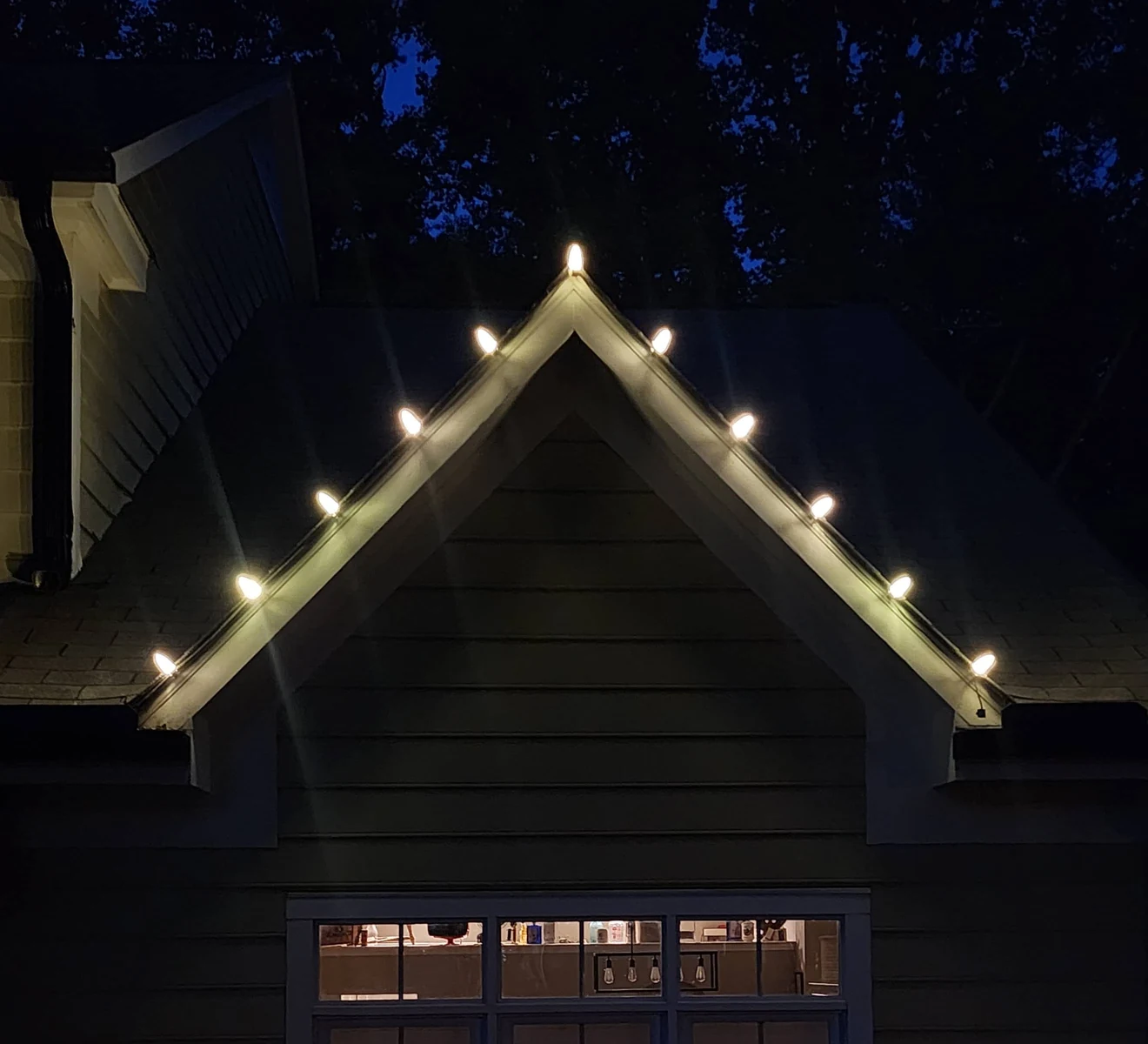 Warm-white bulbs along a gable