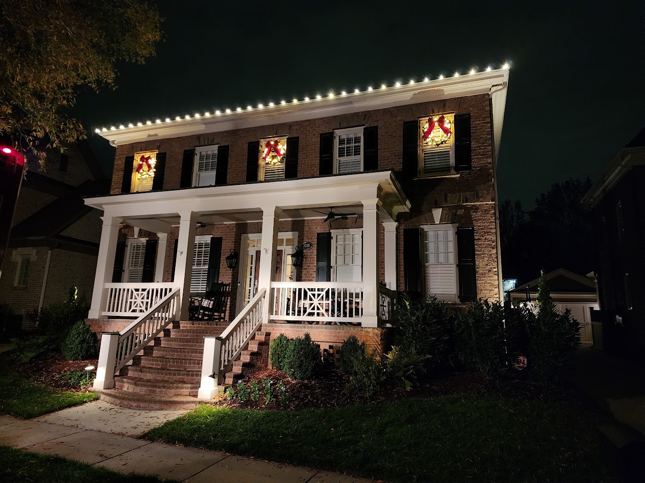 36-inch wreaths on second-story windows at night